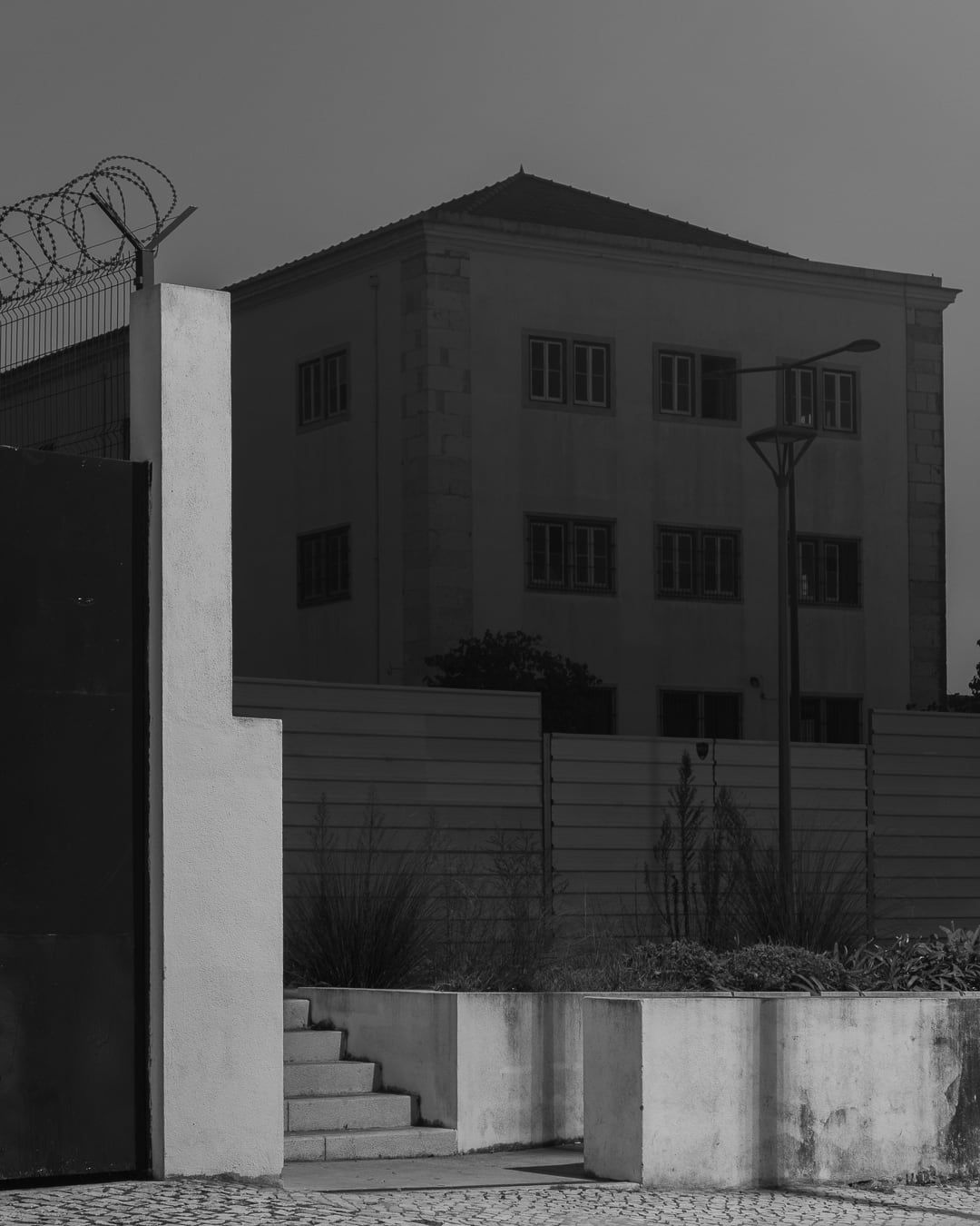 A building behind barbed wire