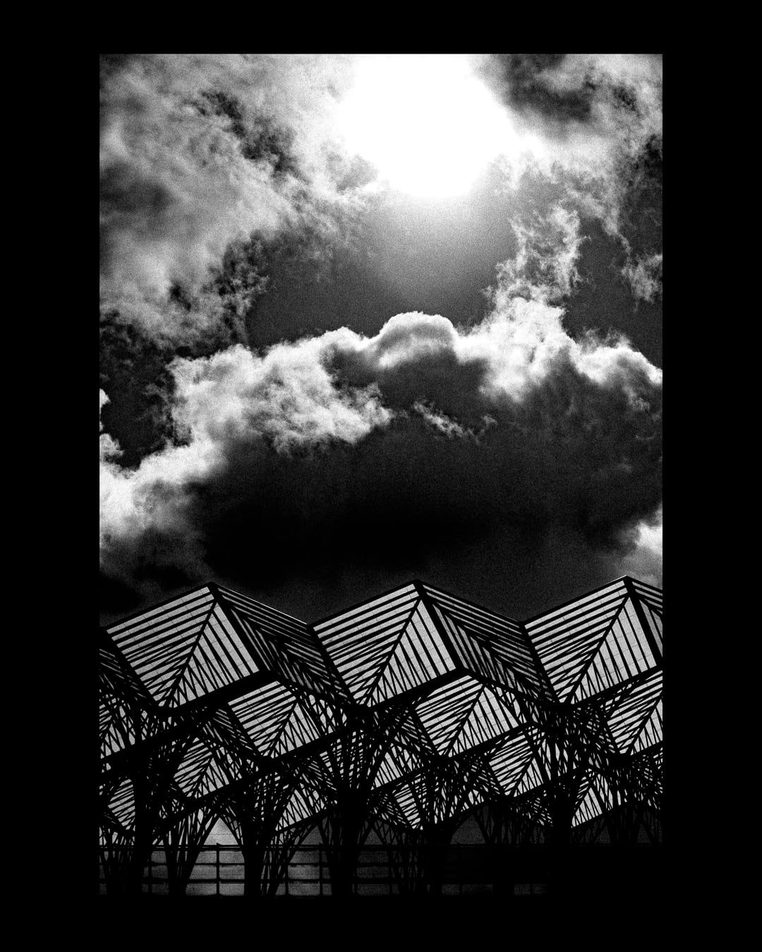 Clouds above a steel canopy