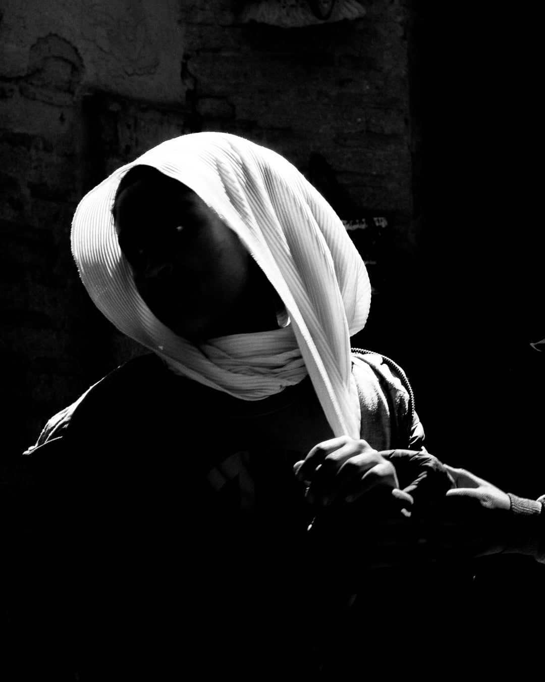 A woman in a headscarf, in profile