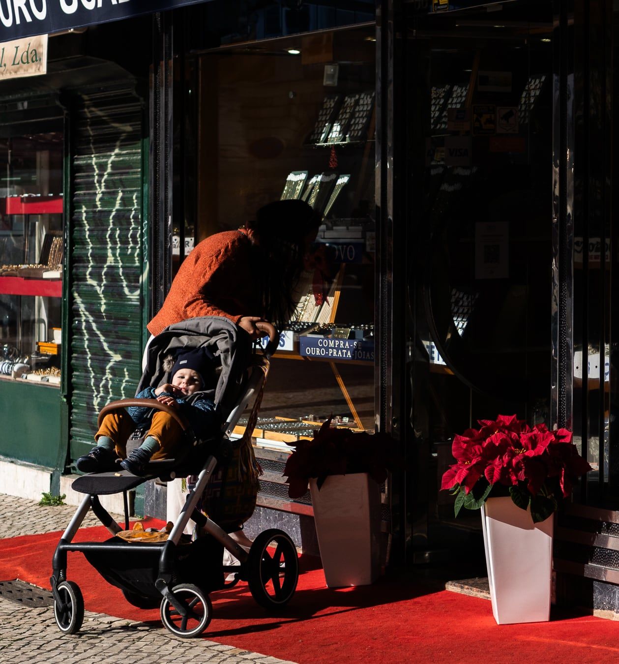 A baby in a stroller on a red carpet